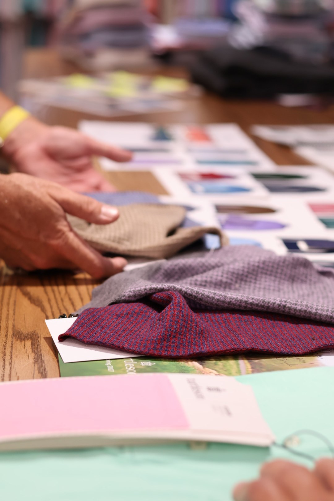 Hands reviewing fabric swatches in the Turtleson design studio
