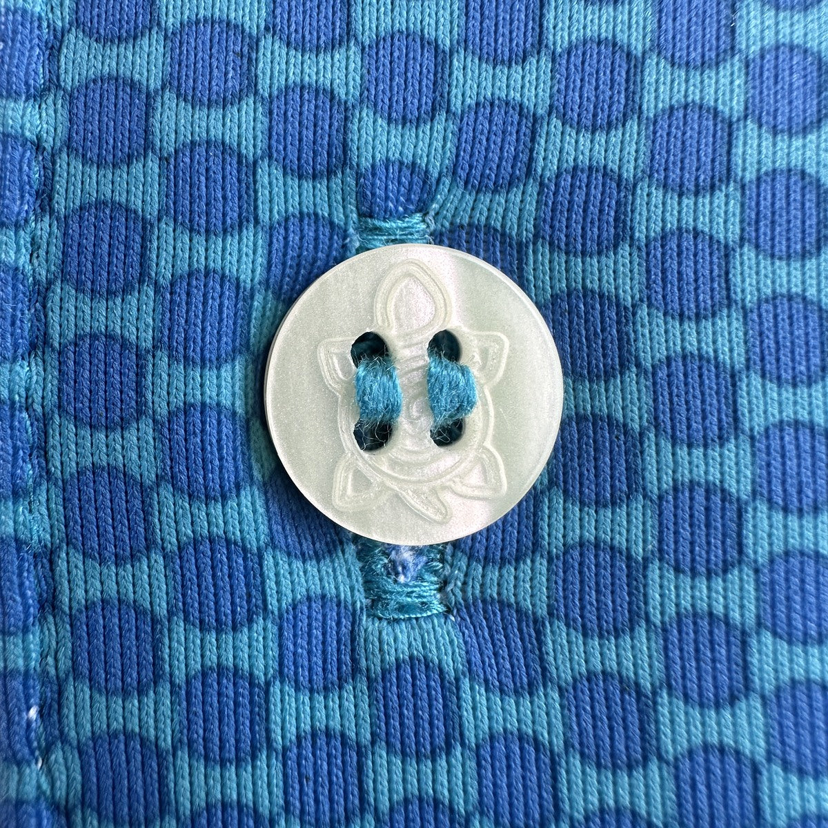 Turquoise 11-Stitch on blue geometric fabric